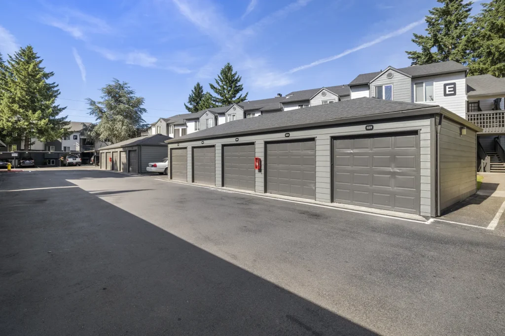 Detached garages in the parking lot with view of residential buildings behind