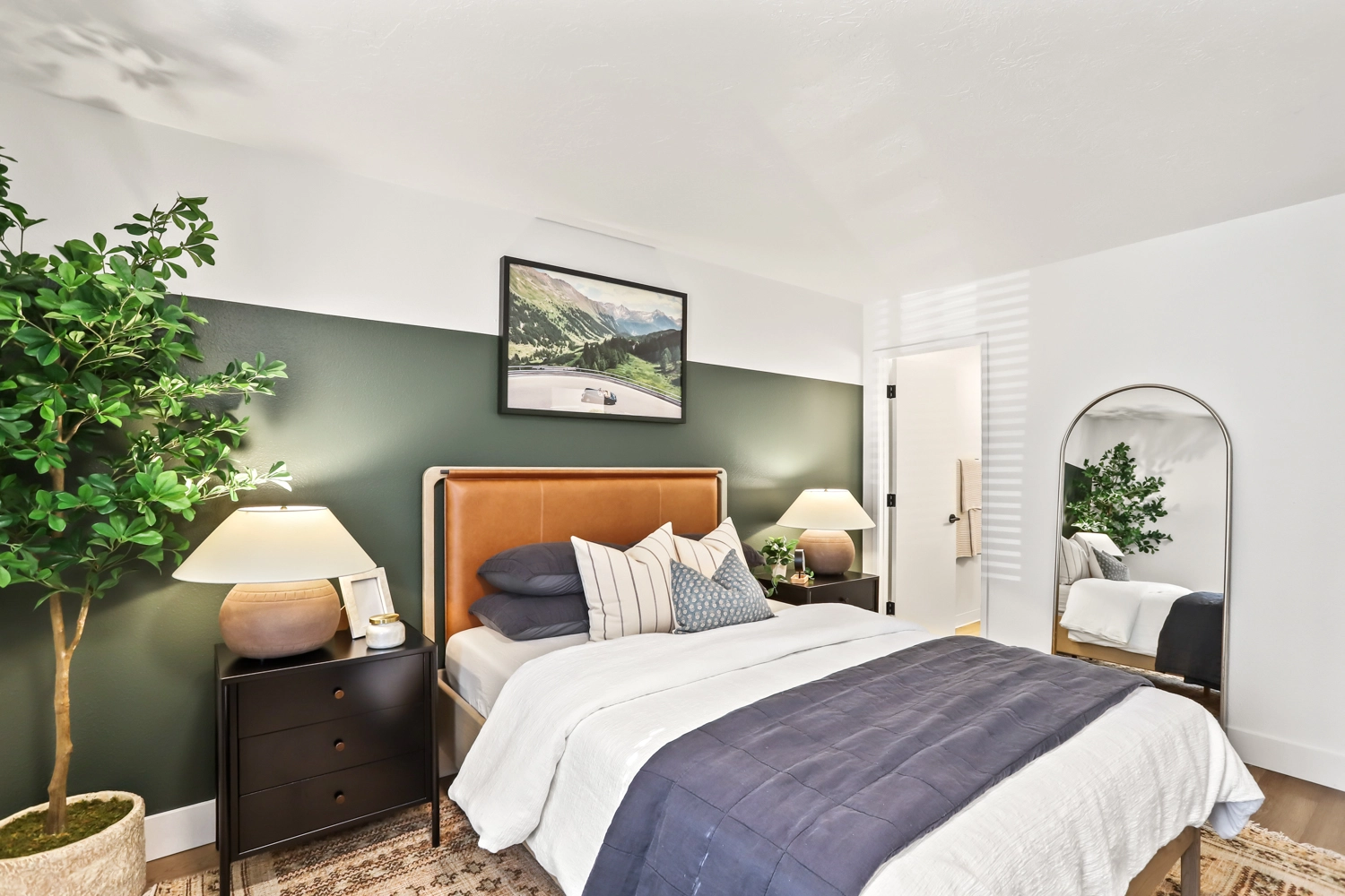 Bedroom with modern furniture, wood-style flooring, and window.