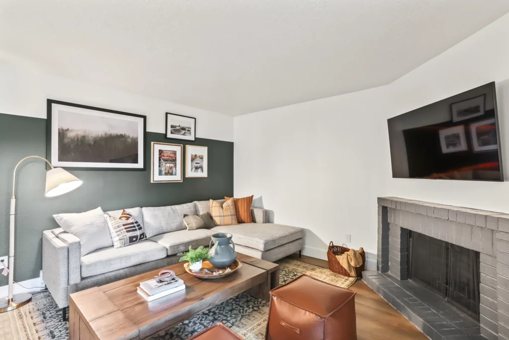 Living room with furniture, modern finishes, and brick fireplace.