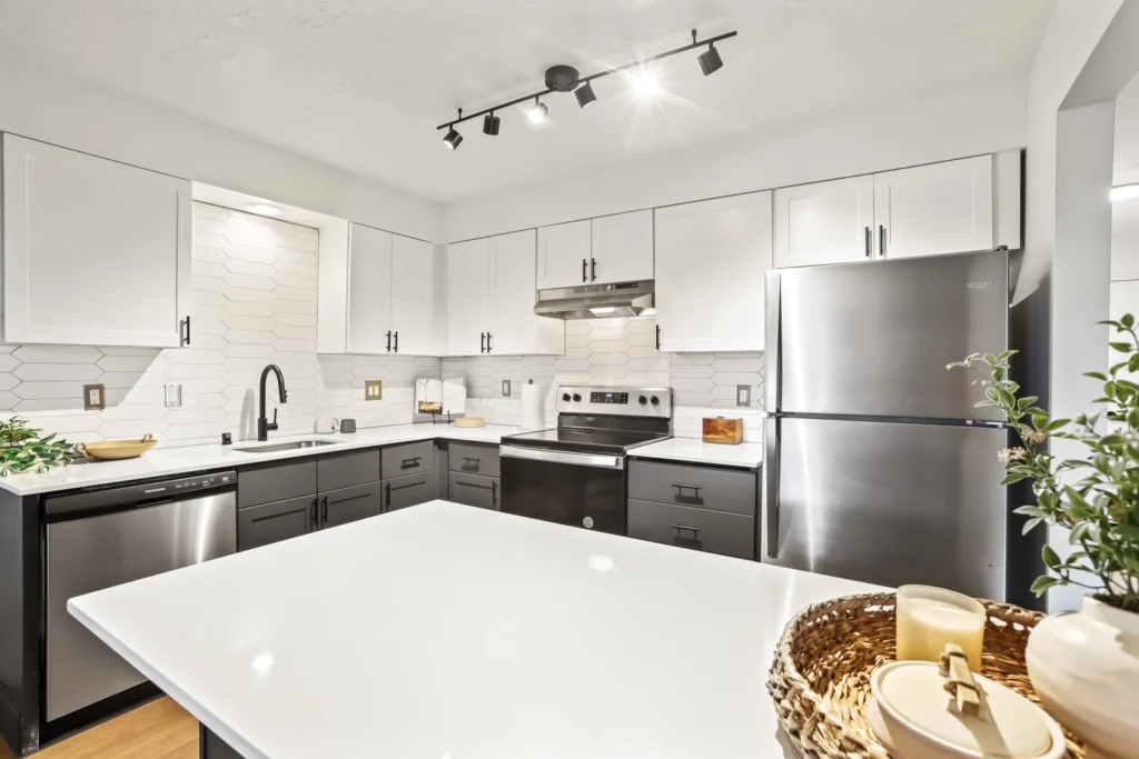 Kitchen with modern cabinetry, stainless steel appliances, island, and designer fixtures.