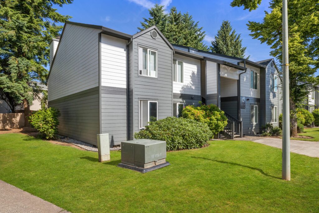 Exterior view of apartment building with trees and sidewalks
