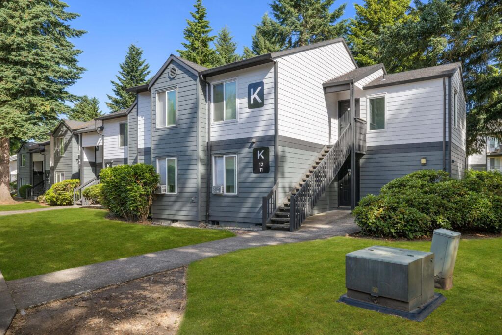 Exterior view of apartment building with trees and sidewalks