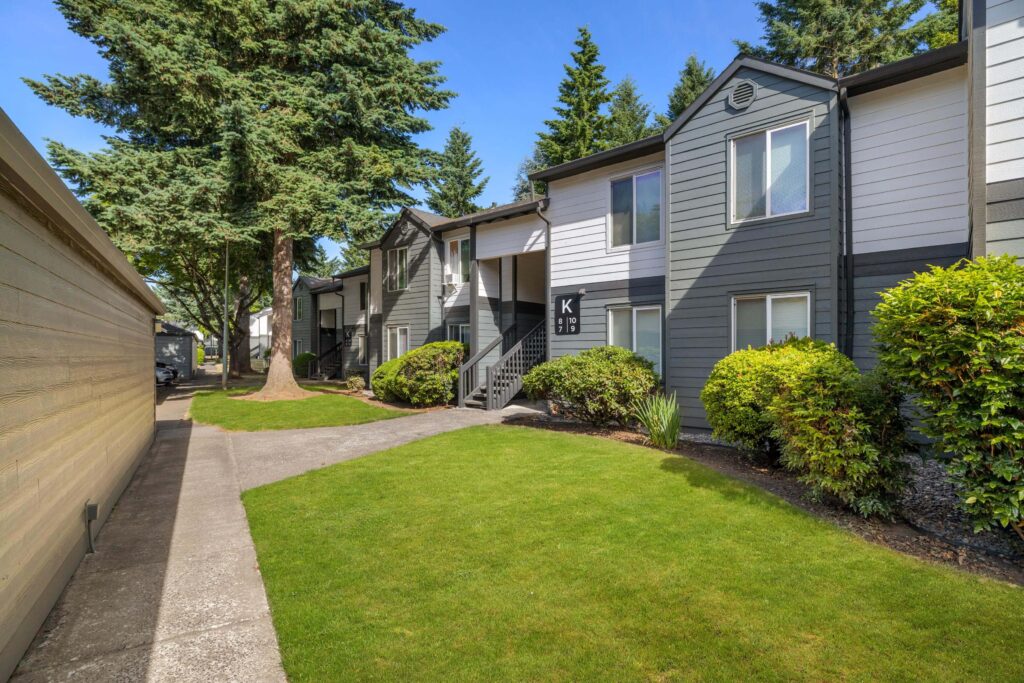 Exterior view of apartment building with trees and sidewalks