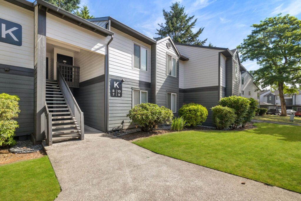 Exterior view of apartment building with trees and sidewalks