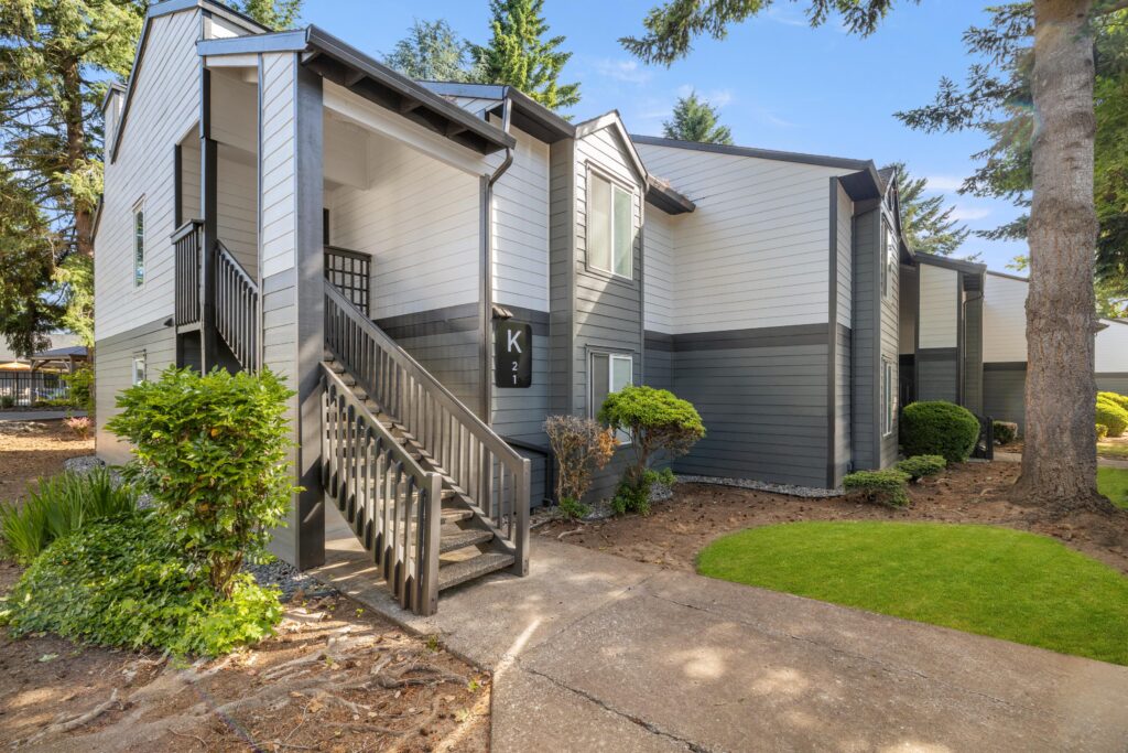 Exterior view of apartment building with trees and sidewalks