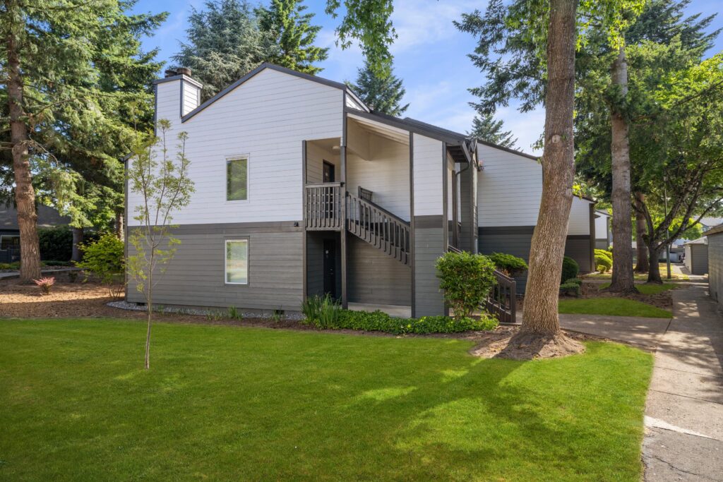 Exterior view of apartment building with trees and sidewalks